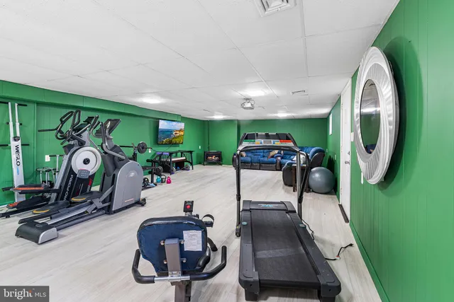 a room with gym equipment and a mirror
