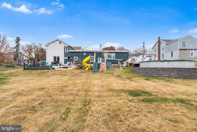 a view of a house with swimming pool and sitting area