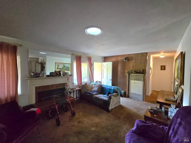 a living room with furniture window and a flat screen tv