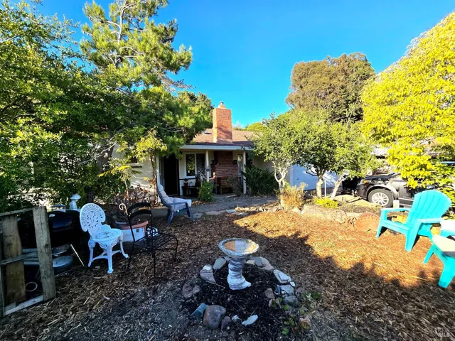 a view of a patio with table and chairs and potted plants