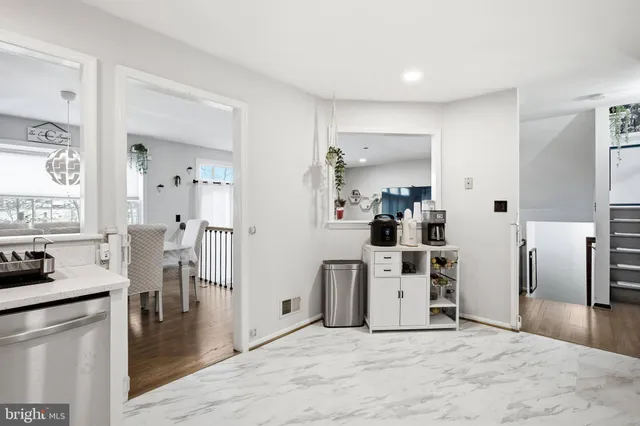 a view of a kitchen with refrigerator stove and wooden floor