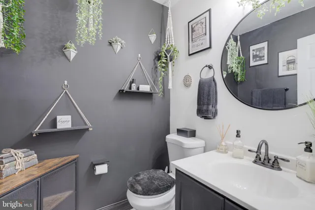 a bathroom with a toilet a sink and mirror