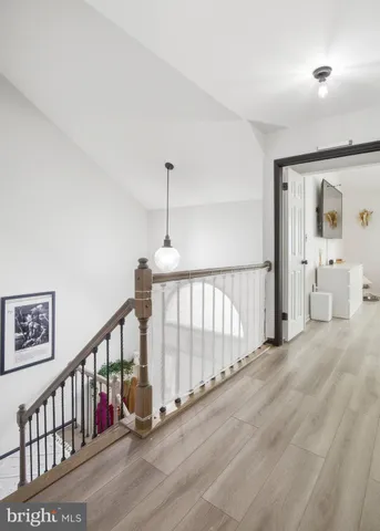 a view of staircase with lots of frames on wall and stairs