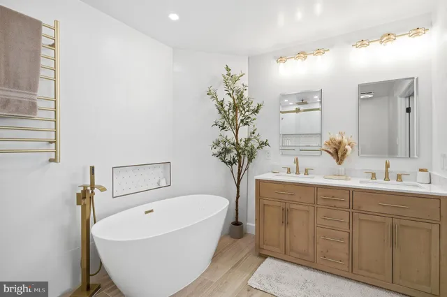 a bathroom with a bathtub a sink and mirror