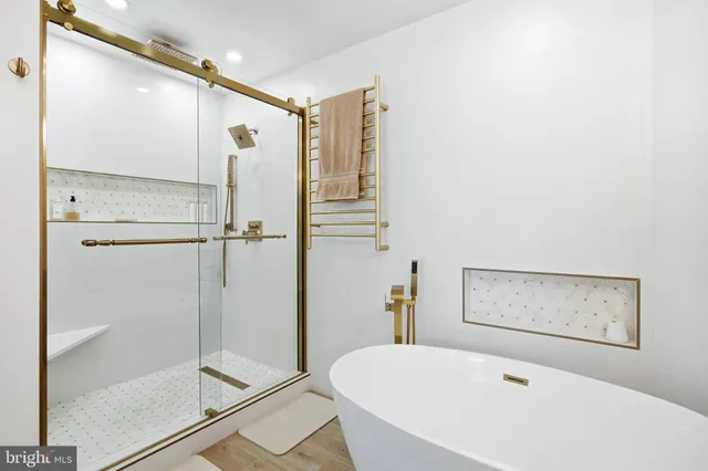 a bathroom with a bathtub and a shower