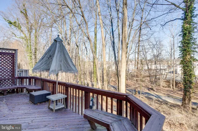 a view of a wooden chairs and fire pit in the balcony