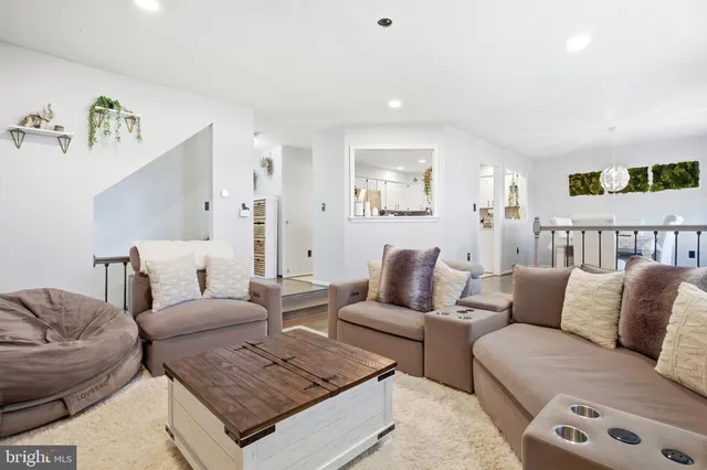 a living room with furniture and painting on the wall