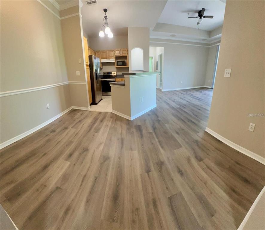 3280 Soho Street, Unit 307 Orlando, FL 32835 - Photo 5 of 34 a view of a kitchen with wooden floor