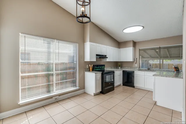 a kitchen with a sink cabinets and stainless steel appliances