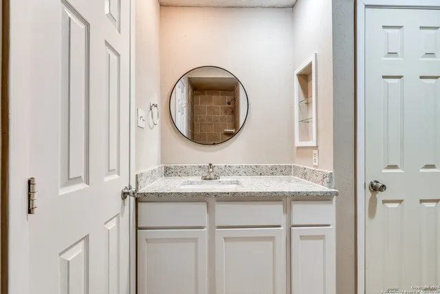 a bathroom with a sink and a mirror