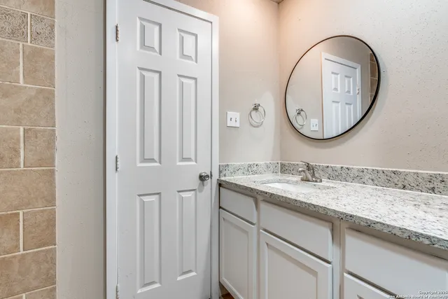 a bathroom with a sink and a mirror