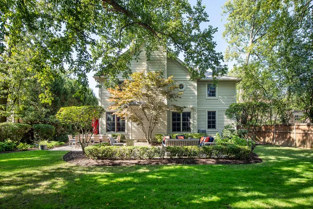 a front view of house with yard and trees