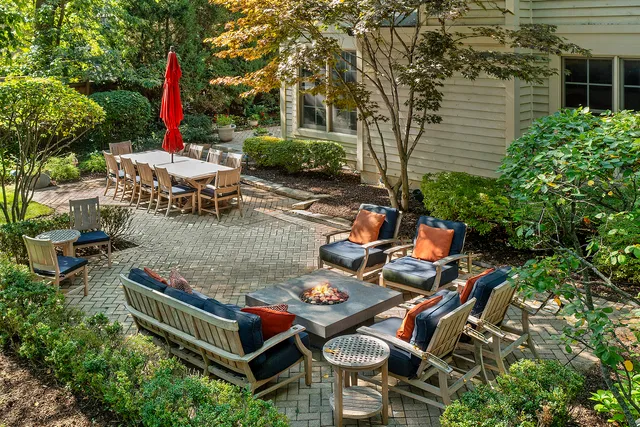 an outdoor sitting area with furniture and wooden deck