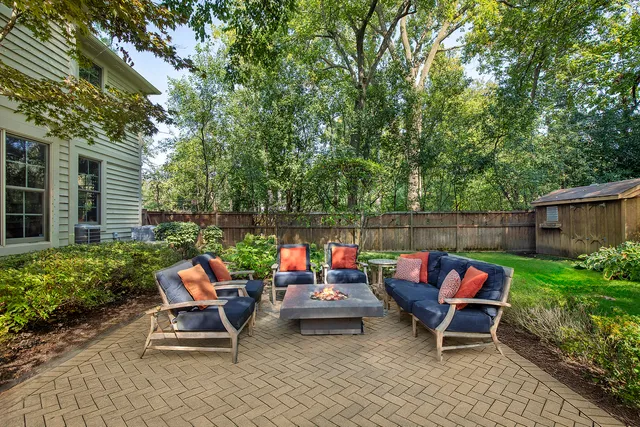 a backyard of a house with outdoor seating