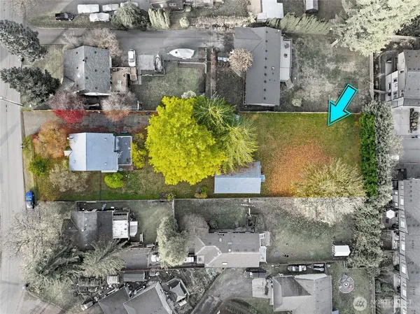 an aerial view of a houses with yard