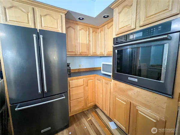 a room with a bed and wooden floor