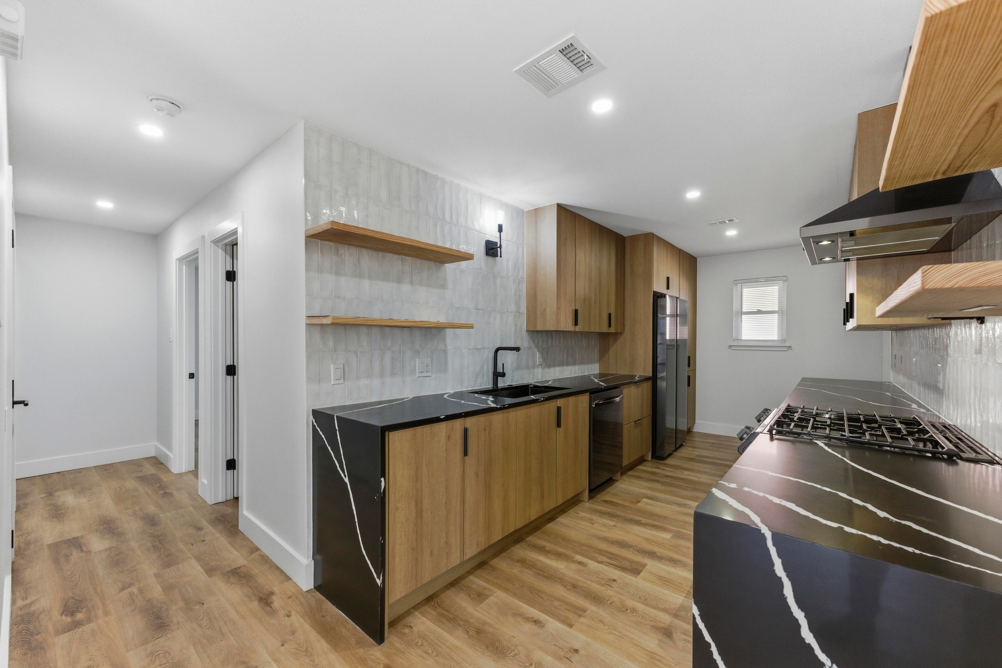 3817 Leafield Drive Austin, TX 78749 - Photo 11 of 31 a kitchen with stainless steel appliances granite countertop a stove a sink and a refrigerator