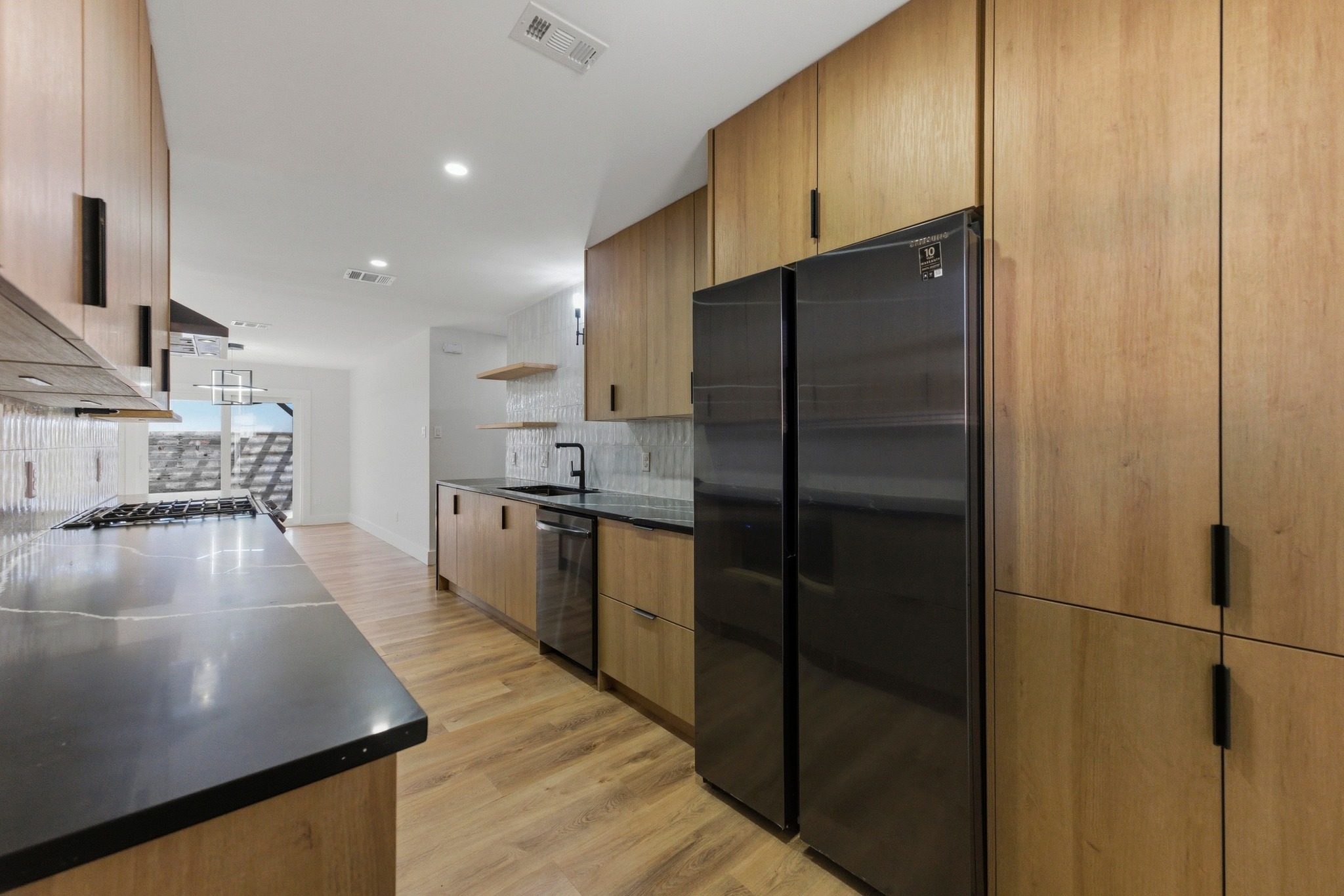 3817 Leafield Drive Austin, TX 78749 - Photo 13 of 31 a kitchen with stainless steel appliances a refrigerator and a stove