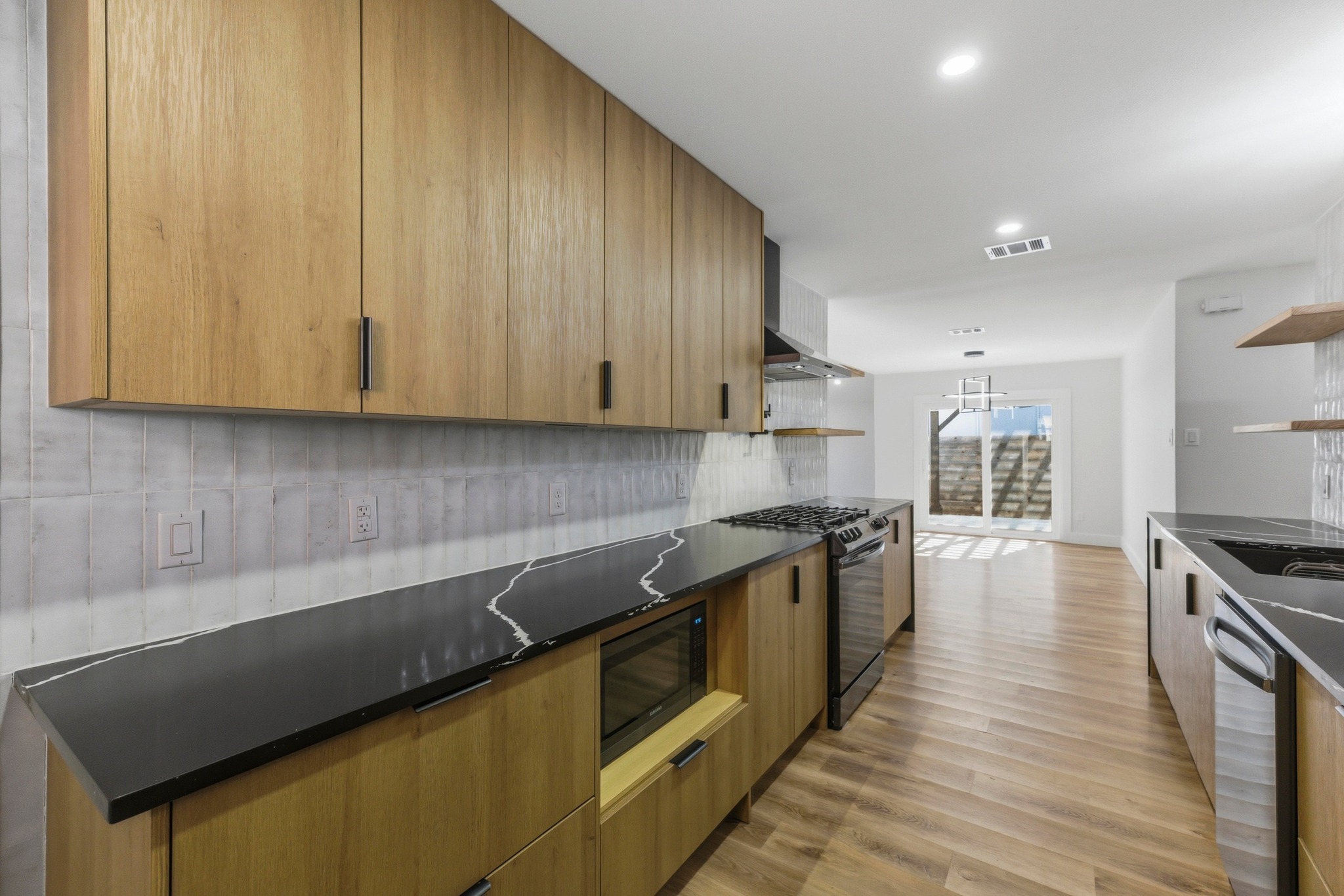 3817 Leafield Drive Austin, TX 78749 - Photo 14 of 31 a kitchen with granite countertop wooden cabinets and stainless steel appliances