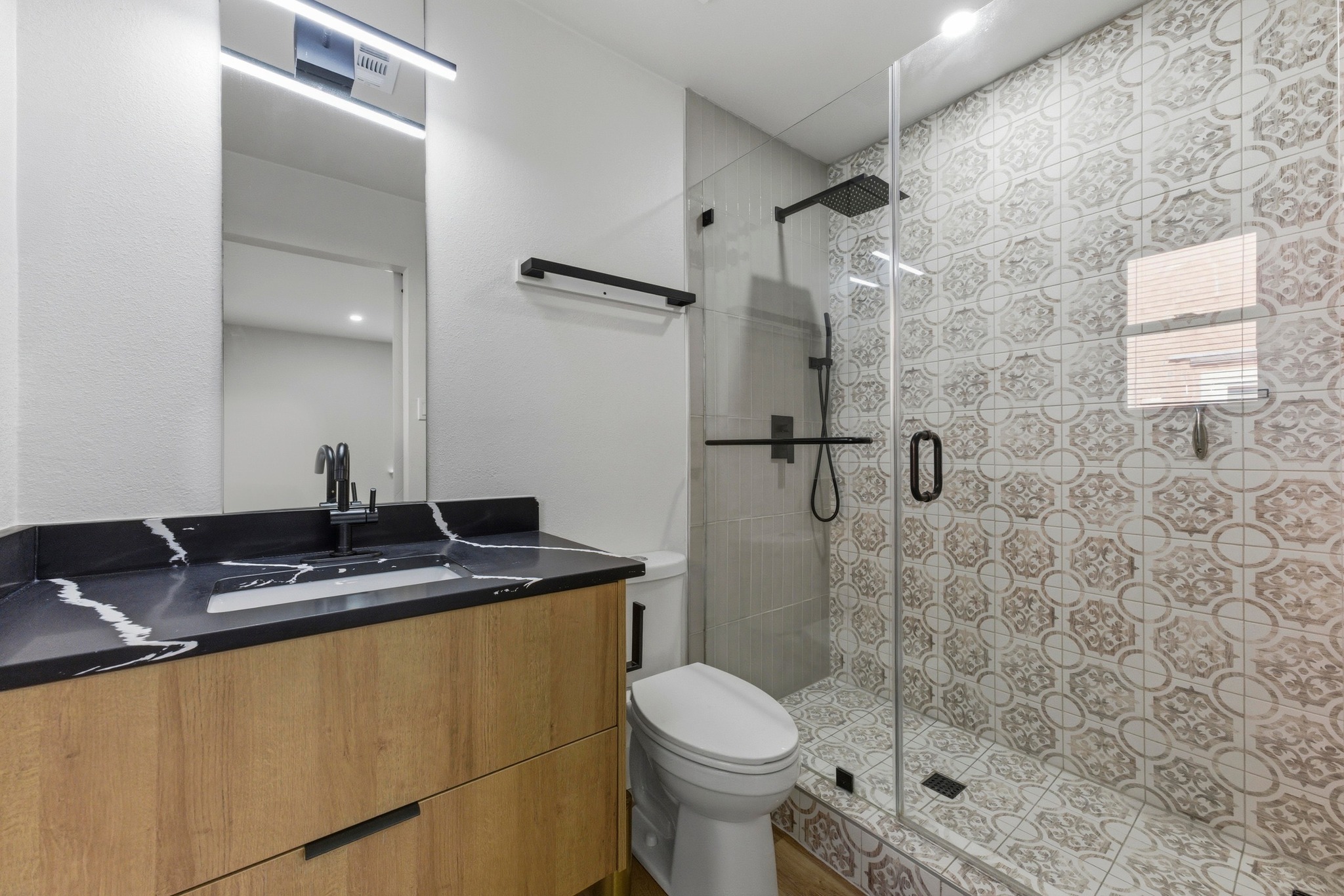 3817 Leafield Drive Austin, TX 78749 - Photo 19 of 31 a bathroom with a granite countertop sink a toilet and shower