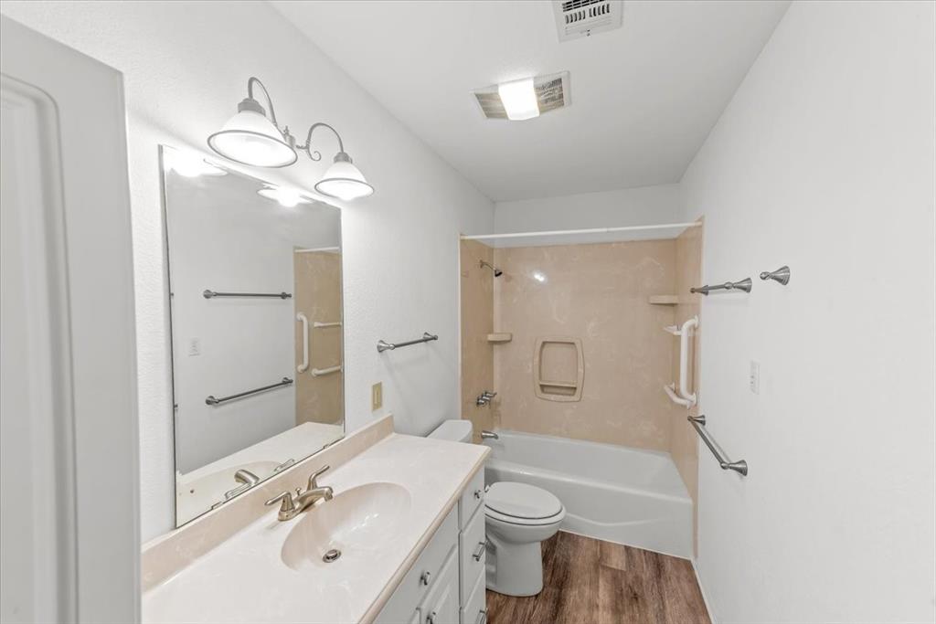 1812 Trinity Drive Waco, TX 76710 - Photo 12 of 24 Bathroom with vanity, shower combination, and vinyl flooring