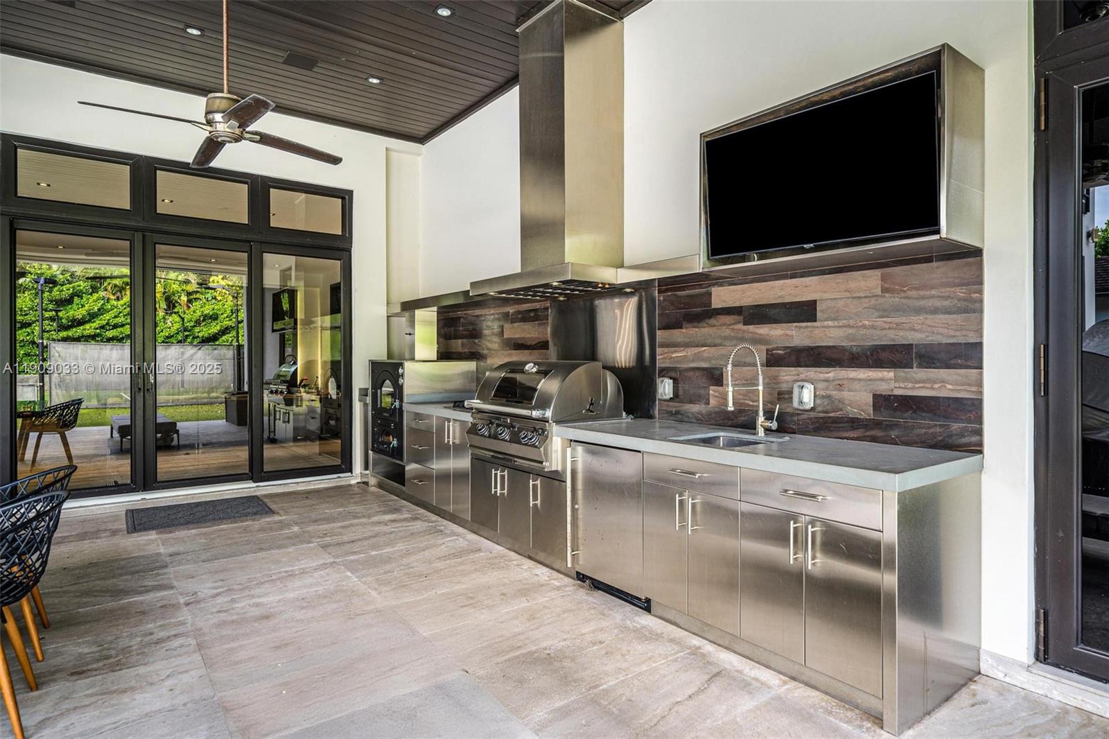 8961 Southwest 62nd Court Pinecrest, FL 33156 - Photo 26 of 72 a kitchen with stainless steel appliances granite countertop a sink and a stove