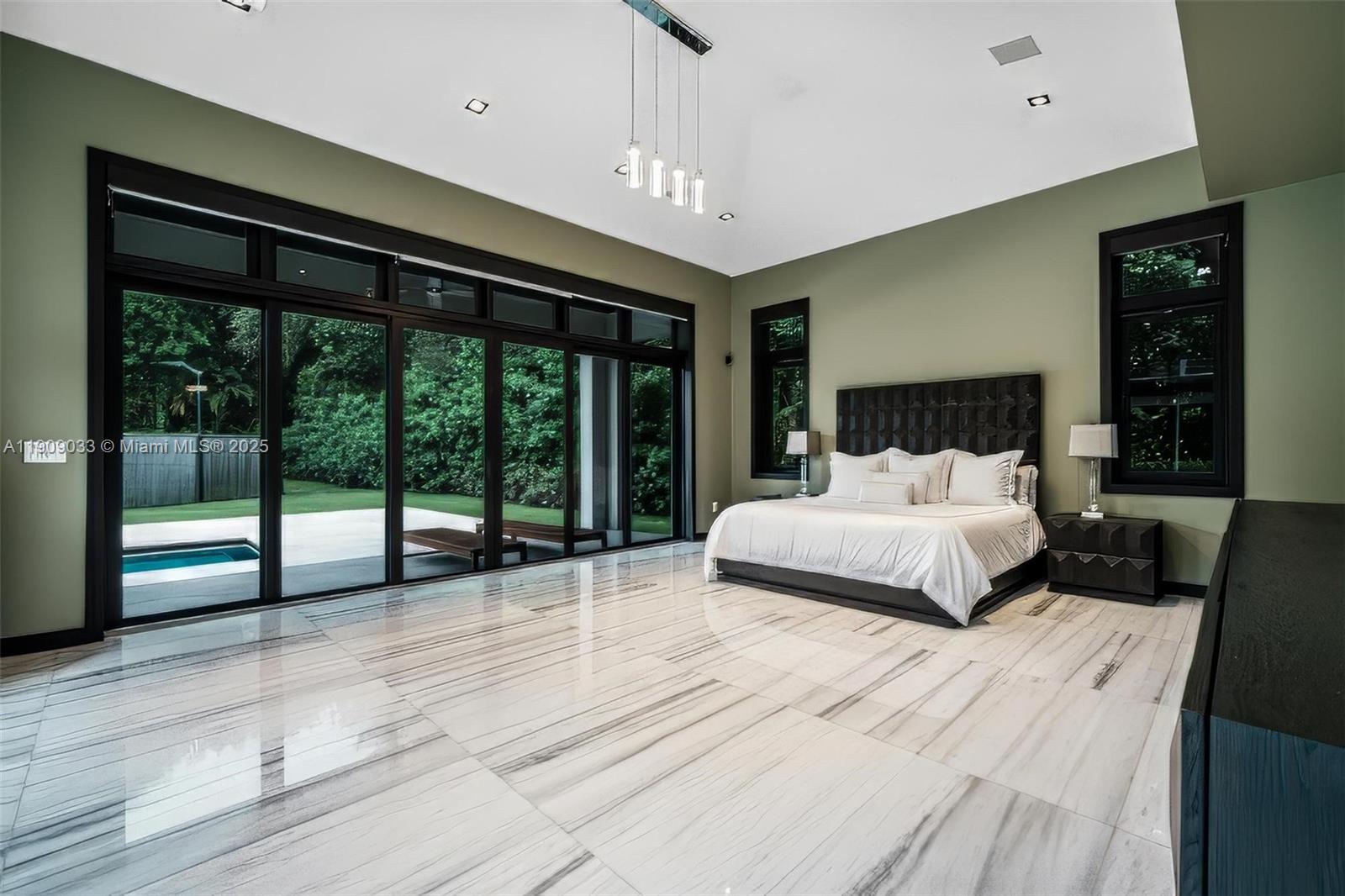 8961 Southwest 62nd Court Pinecrest, FL 33156 - Photo 37 of 72 a bedroom with a large bed and a large window