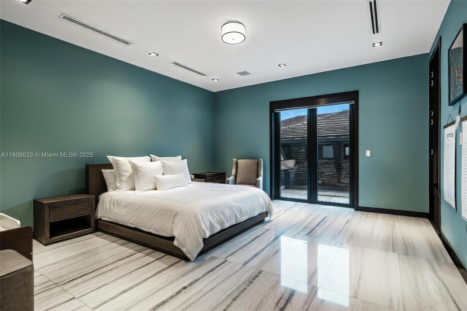 8961 Southwest 62nd Court Pinecrest, FL 33156 - Photo 43 of 72 a bedroom with a large bed and a wooden floor