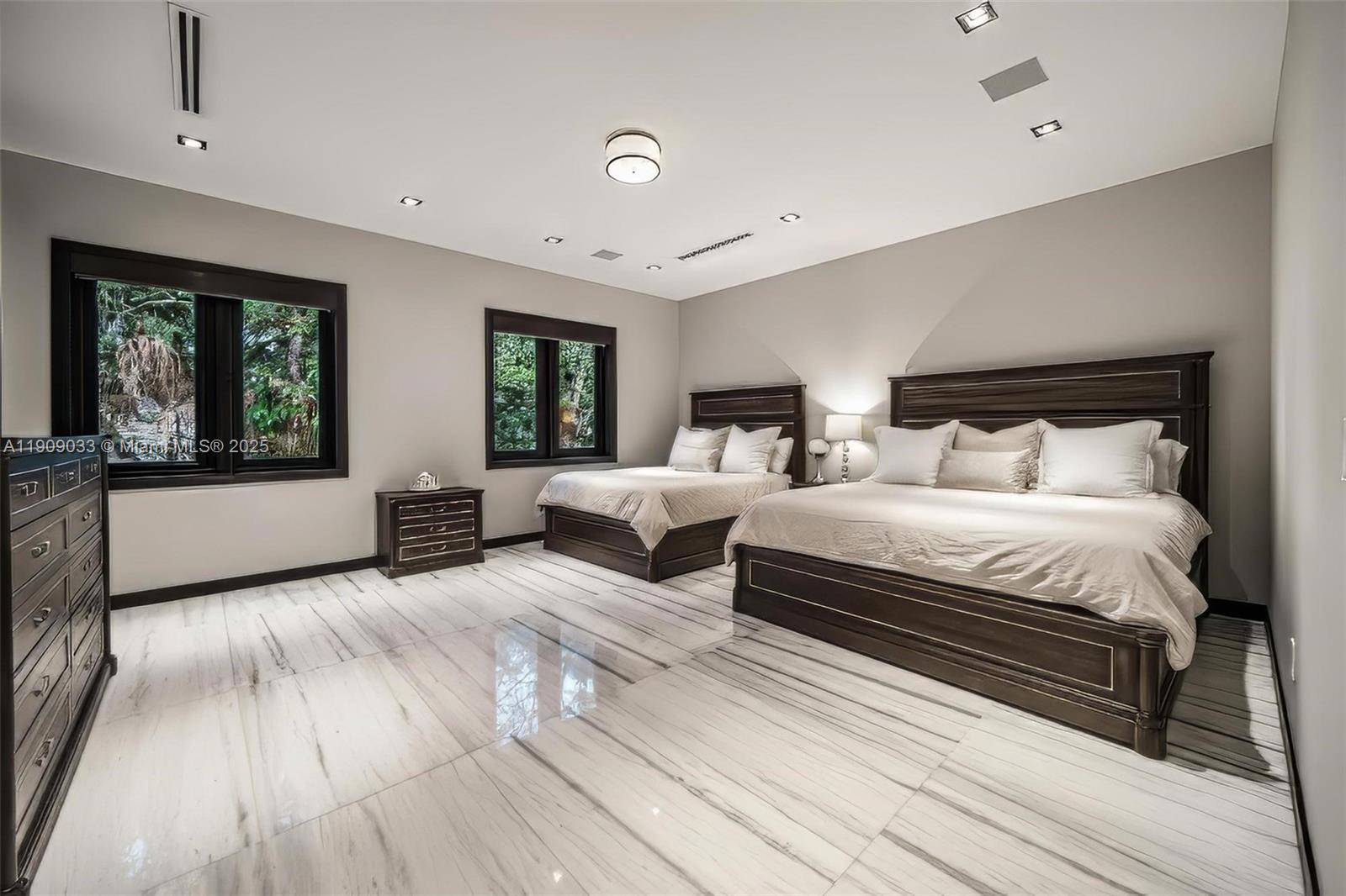 8961 Southwest 62nd Court Pinecrest, FL 33156 - Photo 45 of 72 a spacious bedroom with a bed and large windows