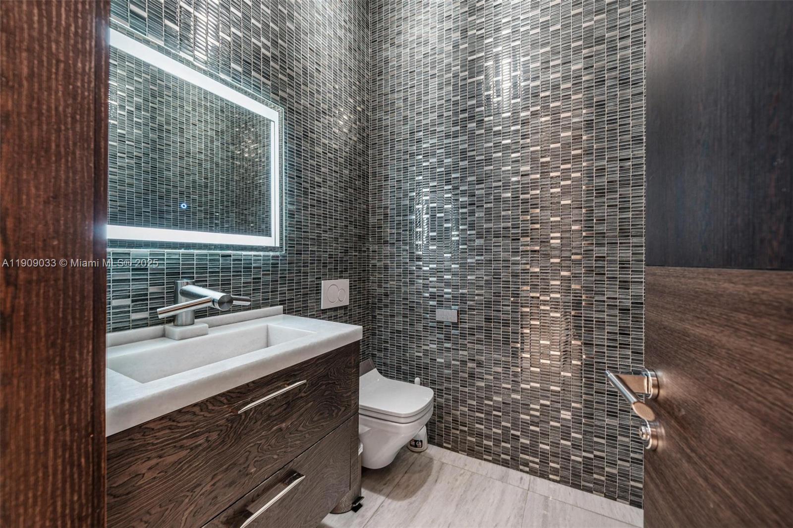 8961 Southwest 62nd Court Pinecrest, FL 33156 - Photo 48 of 72 a bathroom with a sink a toilet and shower