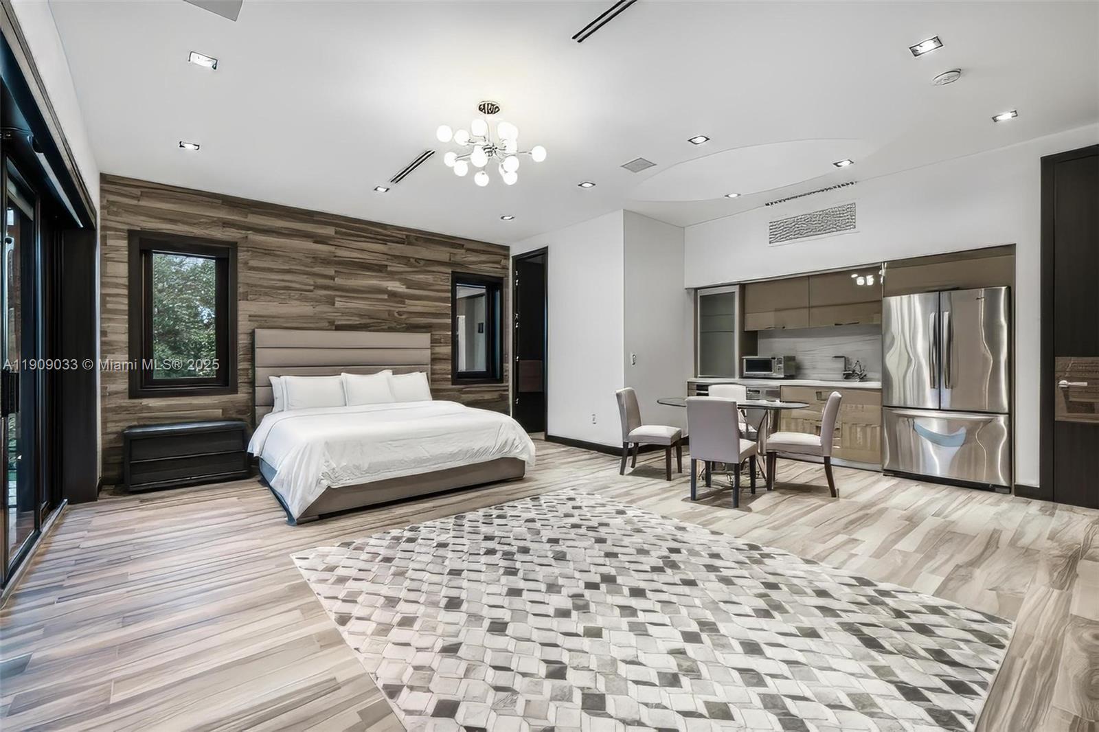 8961 Southwest 62nd Court Pinecrest, FL 33156 - Photo 50 of 72 a bedroom with a bed and wooden floor