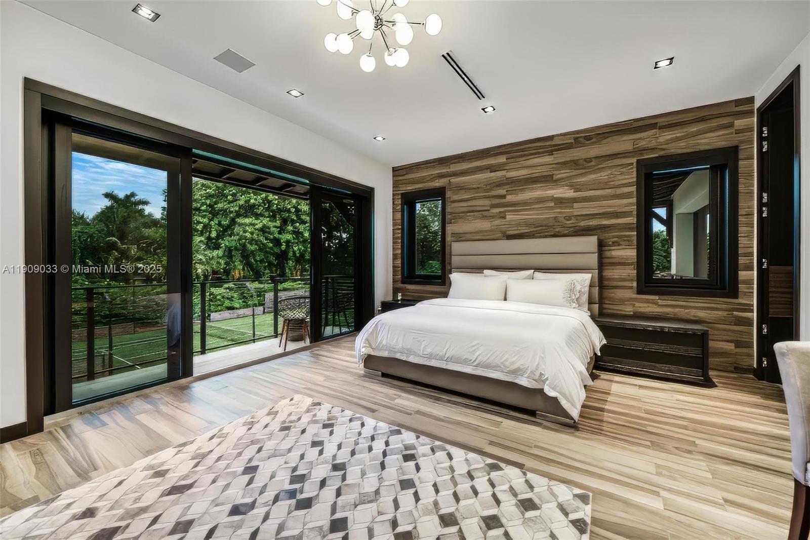 8961 Southwest 62nd Court Pinecrest, FL 33156 - Photo 51 of 72 a bedroom with a large bed and a large window