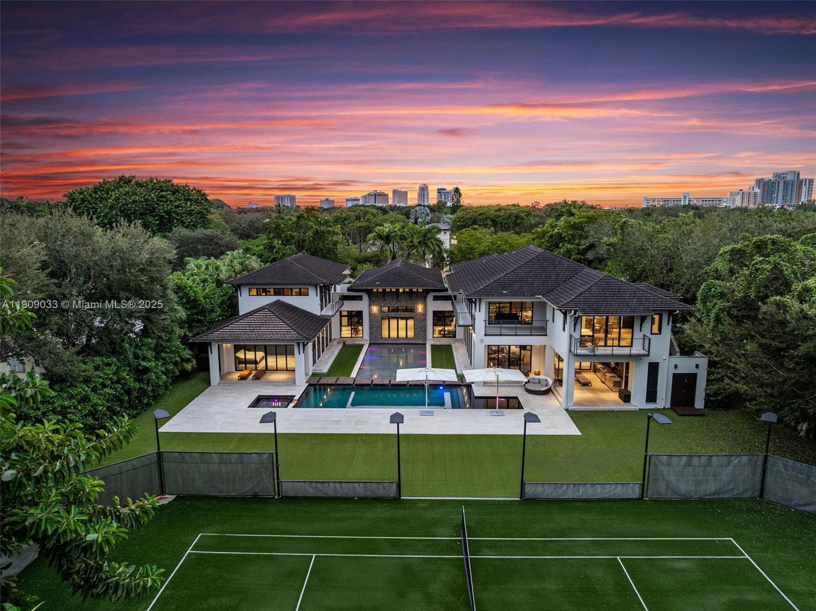 8961 Southwest 62nd Court Pinecrest, FL 33156 - Photo 68 of 72 a front view of a house with a big yard