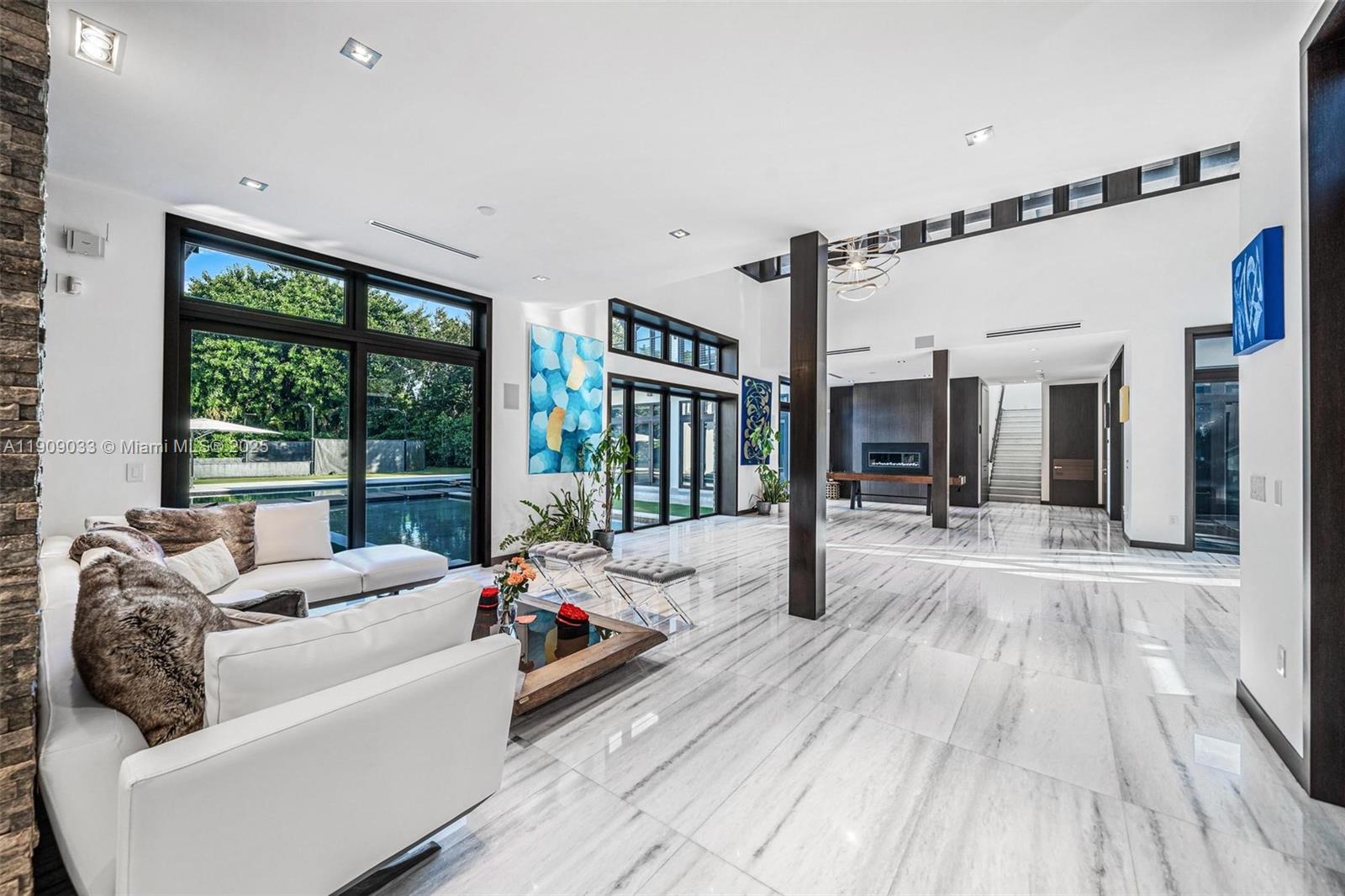 8961 Southwest 62nd Court Pinecrest, FL 33156 - Photo 7 of 72 a living room with furniture and large windows
