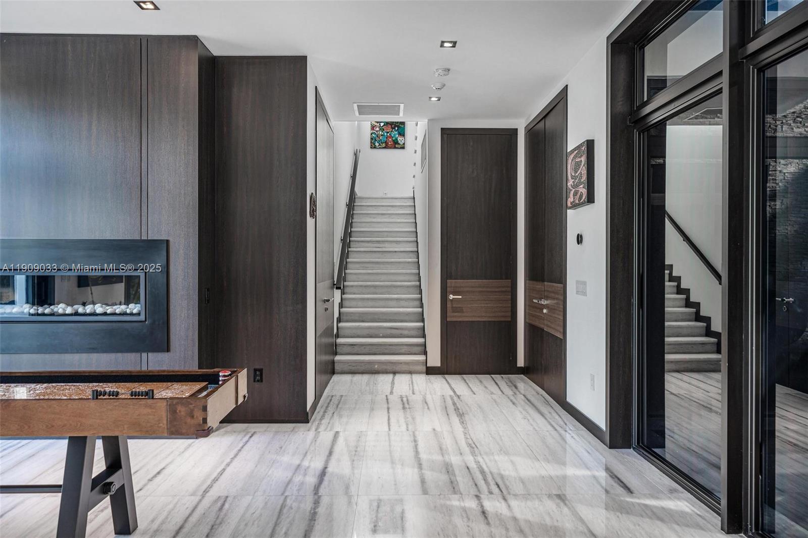 8961 Southwest 62nd Court Pinecrest, FL 33156 - Photo 8 of 72 a view of a hallway with wooden floor and staircase