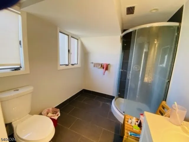 a bathroom with a toilet and a shower