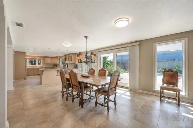 a view of a dining room with furniture and a floor to ceiling window