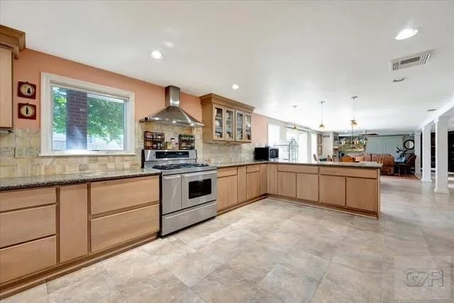 a kitchen with stainless steel appliances granite countertop a stove and a sink