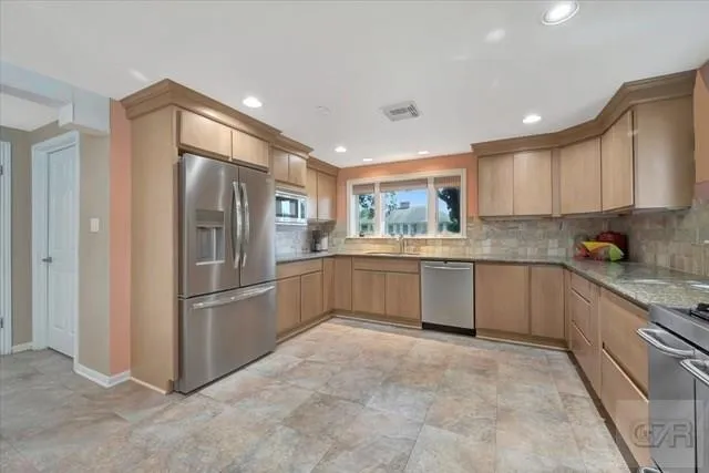 a kitchen with a refrigerator and a sink