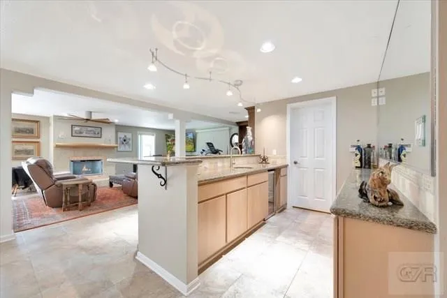 a kitchen with stainless steel appliances granite countertop a sink and a refrigerator