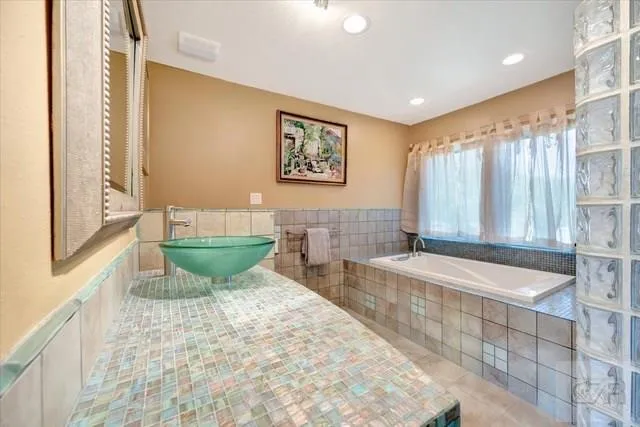 a spacious bathroom with a bathtub and sink