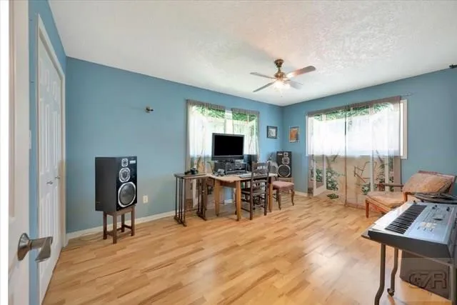 a view of a livingroom with workspace and a window