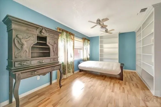 a living room with a bed furniture and a window