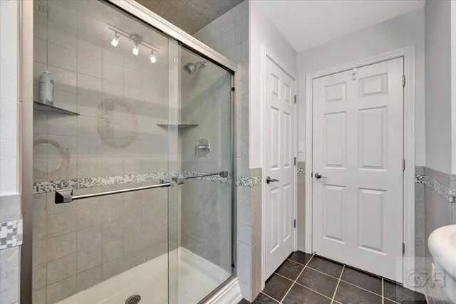 a bathroom with a glass shower door