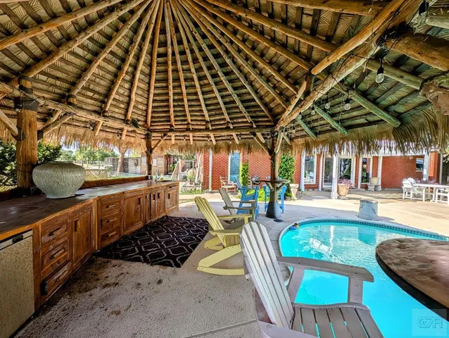 a view of a swimming pool with a patio