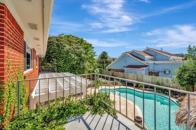 a view of a balcony with yard