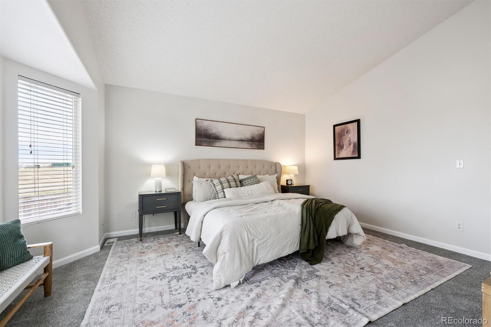 5241 Helena Street Denver, CO 80239 - Photo 12 of 28 a bedroom with a bed and wooden floor