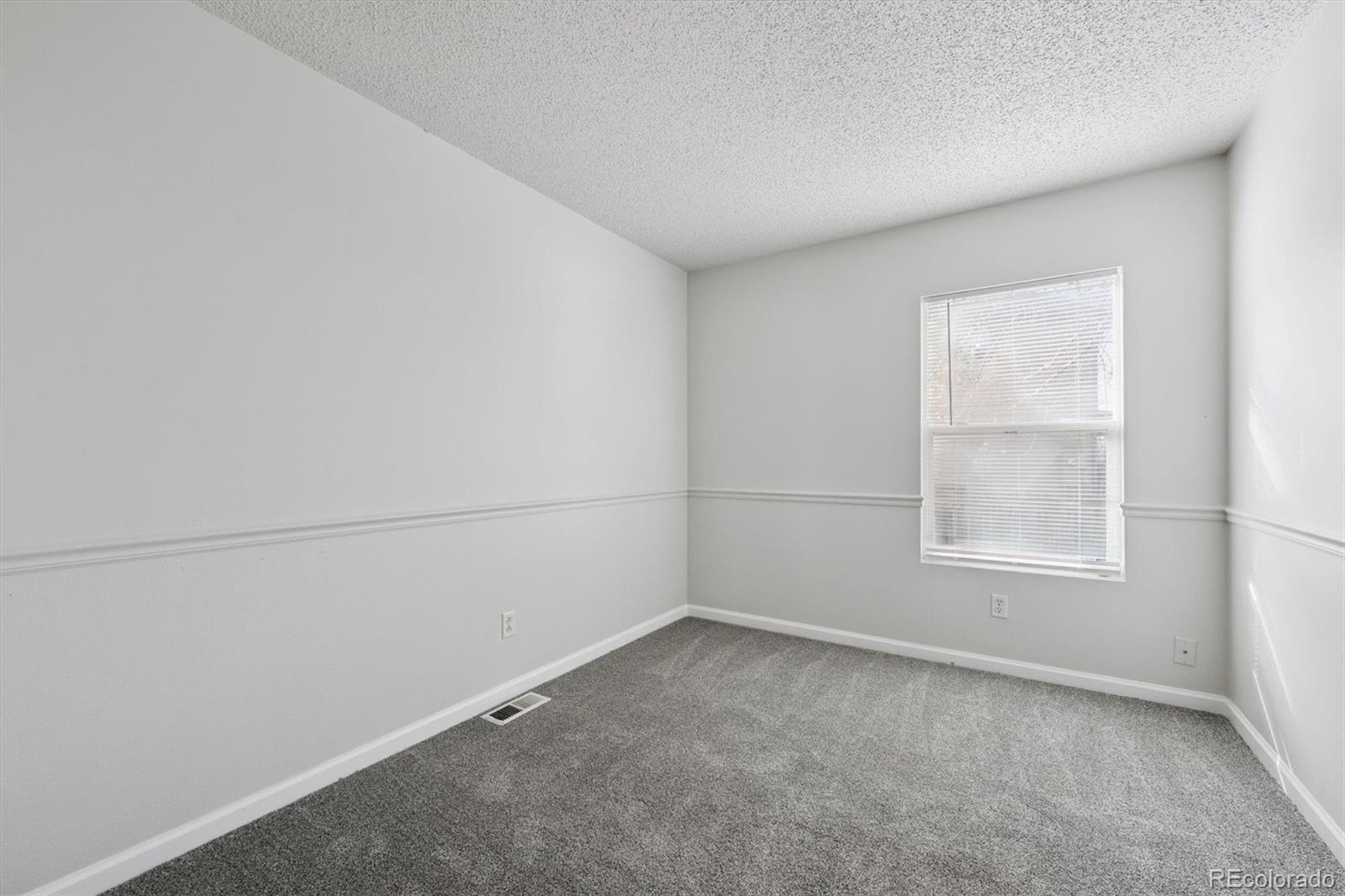 5241 Helena Street Denver, CO 80239 - Photo 15 of 28 an empty room with a window