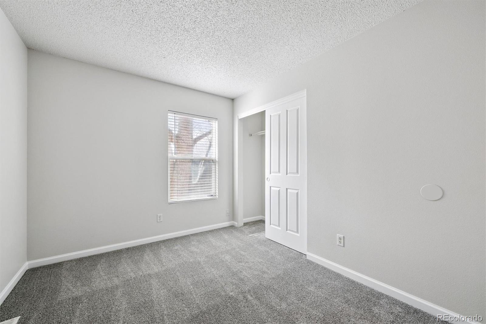 5241 Helena Street Denver, CO 80239 - Photo 16 of 28 a view of an empty room with a window