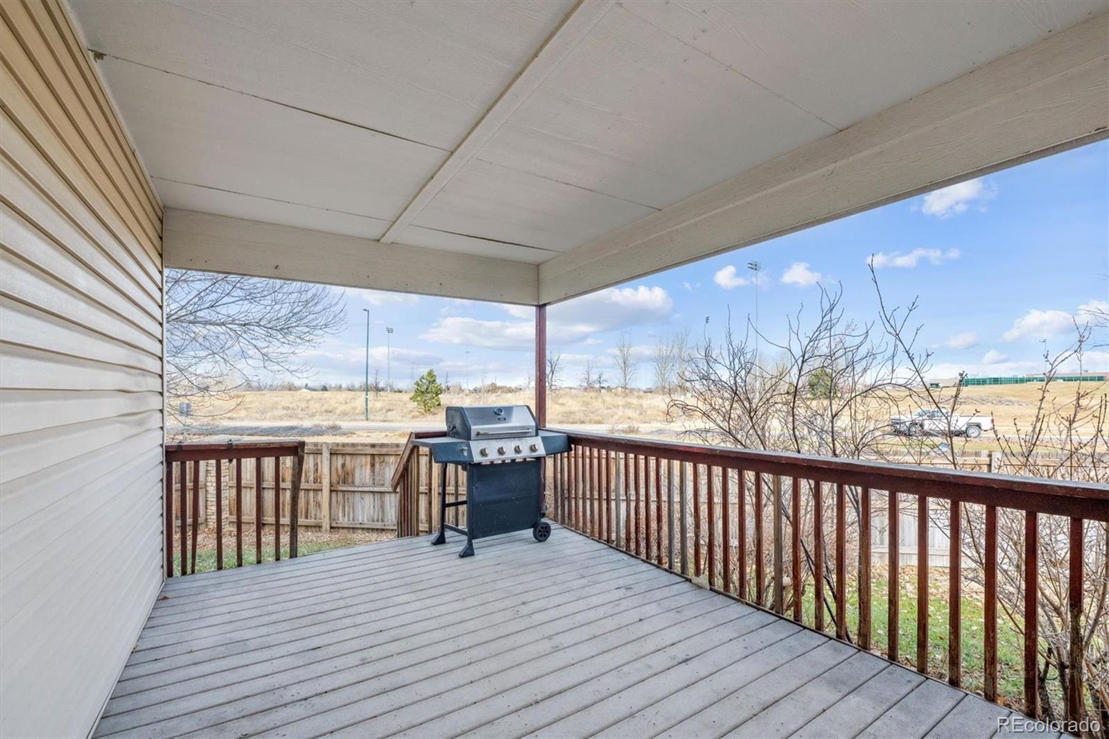 5241 Helena Street Denver, CO 80239 - Photo 21 of 28 a view of a balcony with wooden floor
